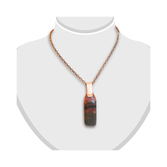 Long variegate jasper pendant with copper staple displayed on white bust.
