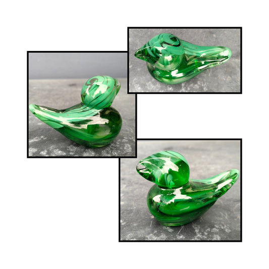 Handblown green glass bird by Heather Kremen with smooth curves and glossy finish.