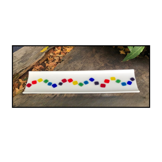 Rectangular opaque white fused glass sushi tray with a central wave of colourful squares in a mock up

