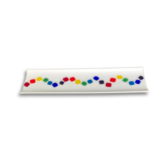 Rectangular opaque white fused glass sushi tray with a central wave of colourful squares, handcrafted by Jill Matthew on whaite

