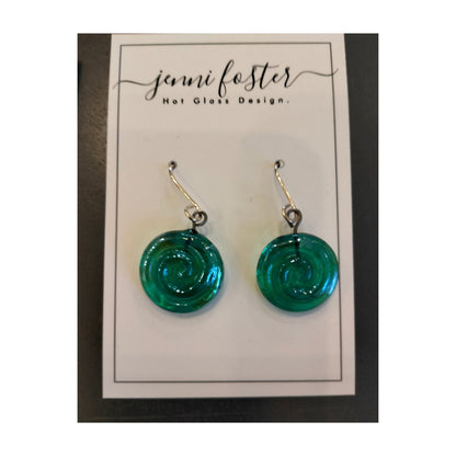 Jenni Foster’s round glass koru earrings in green,  displayed on jewellery card.