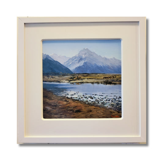 Horseman Tasman Valley, original oil on board by Don Hill, two horsemen mustering cattle below Aoraki Mount Cook with river and tussock flats, white mat and frame


