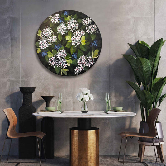 Dining room with a round floral painting of Indian Hawthorn on the wall, marble table, and chairs.
