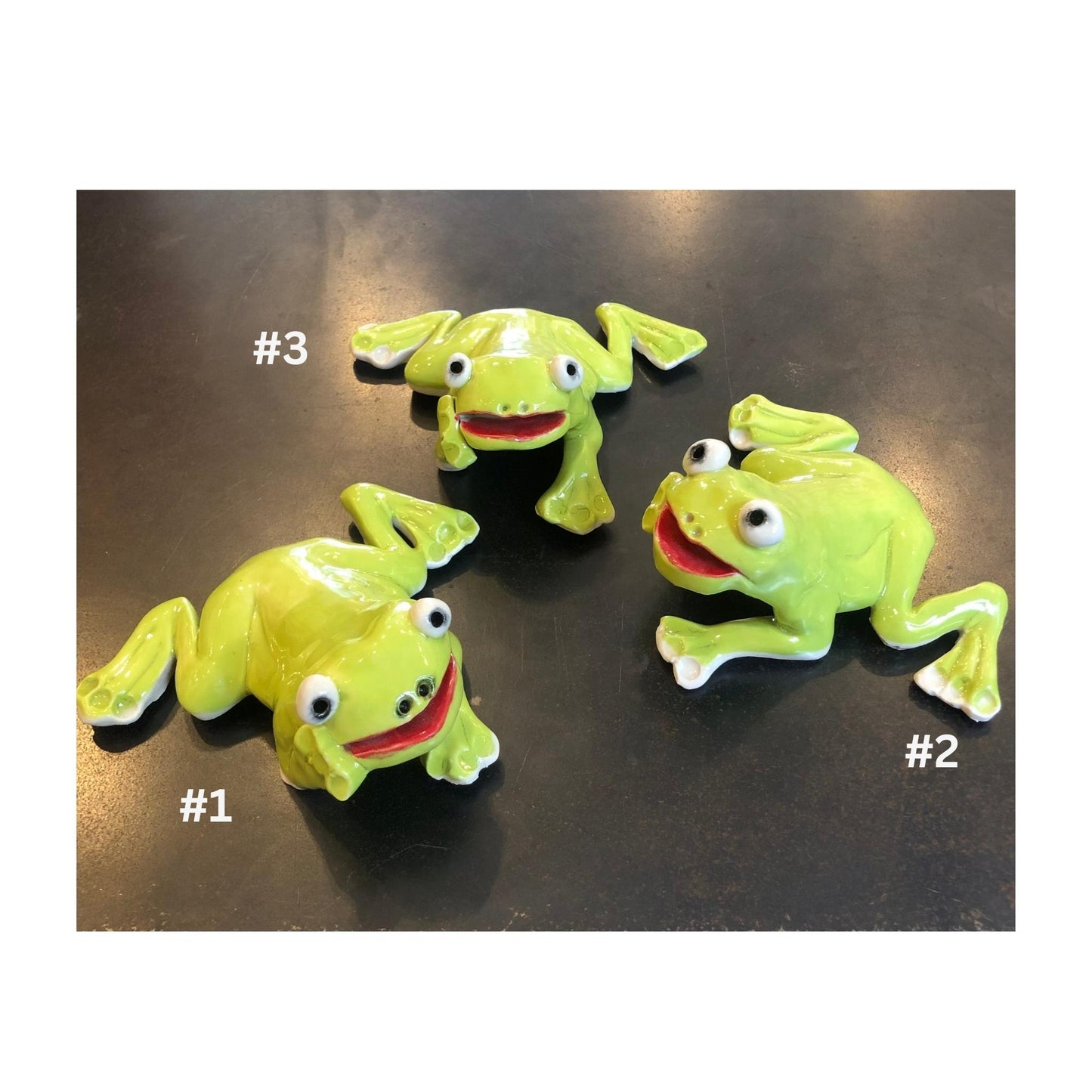 Three lime green ceramci frog figurines on a reflective surface with numbers indicating their order.