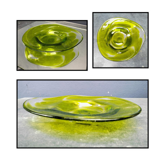 Handcrafted lime green glass platter with organic swirled design shown from side angle