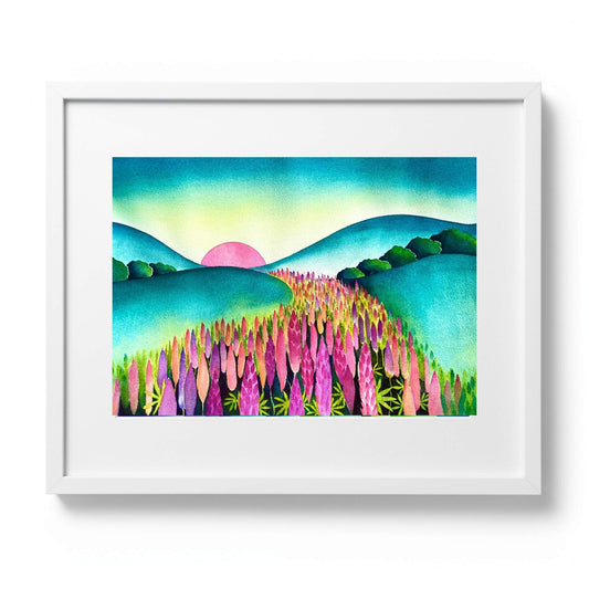 Original watercolour painting of pink and purple lupins in a NZ landscape at sunrise with teal rolling hills, by Raewyn Harris, 67 × 52cm, presented in a white frame.
