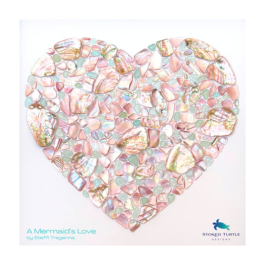 Heart mosaic artwork made from NZ pink mussel shell, pastel blue sea glass and Chilean abalone by artist Steffi Tregenna, close up
