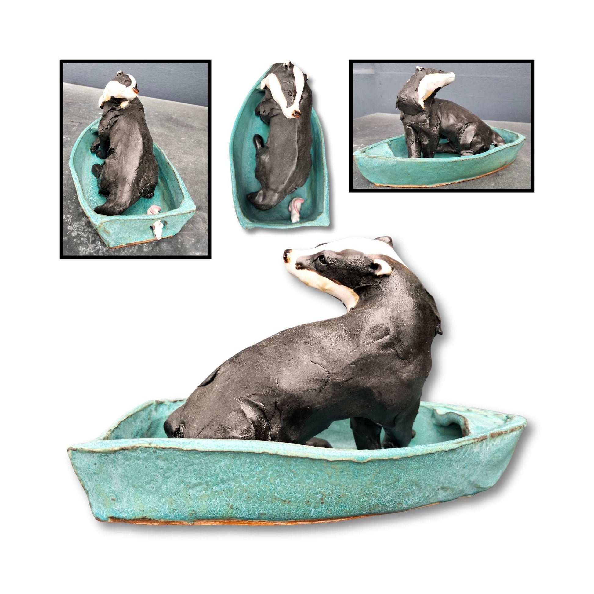 Ceramic sculpture of a black and white badger in a teal blue boat with a small mouse peeking from the back. Handmade by Kylie Matheson.
