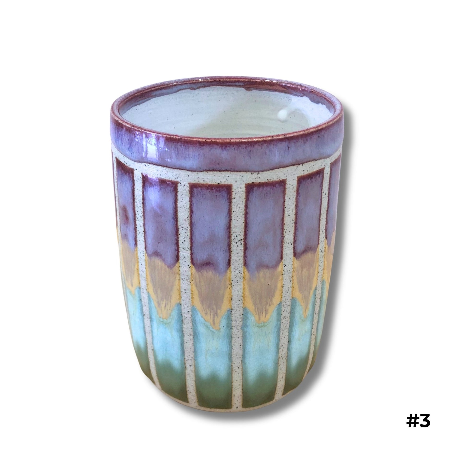 Handmade ceramic vase with purple, gold, and aqua dripping glazes and carved vertical lines by Karene Fairey
