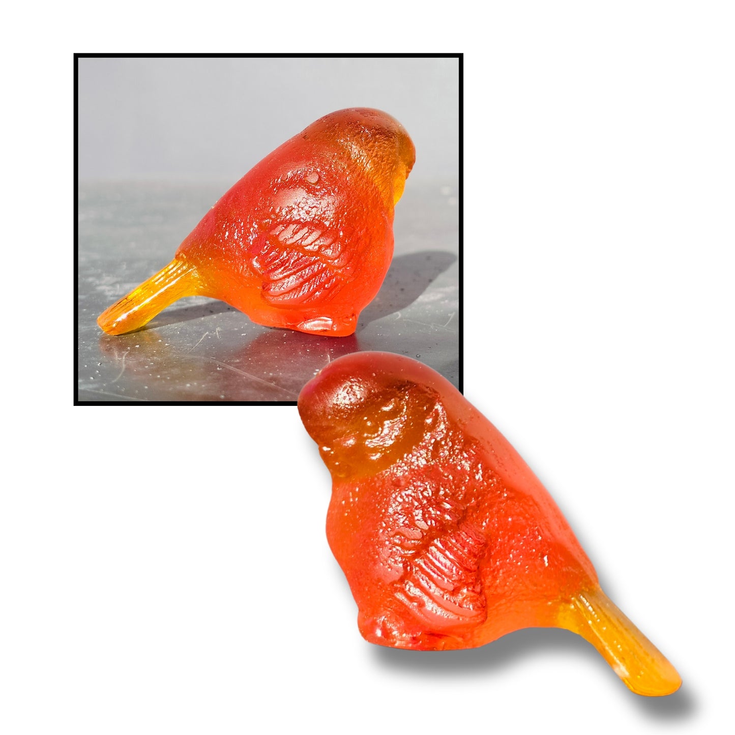 Small cast glass bird sculpture in orange with tail down by Lou Mathieson, 5x4x4cm, on white background
