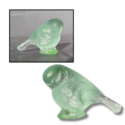 Small cast glass bird sculpture in plae turquoise with tail down by Lou Mathieson, 5x4x4cm, on white background
