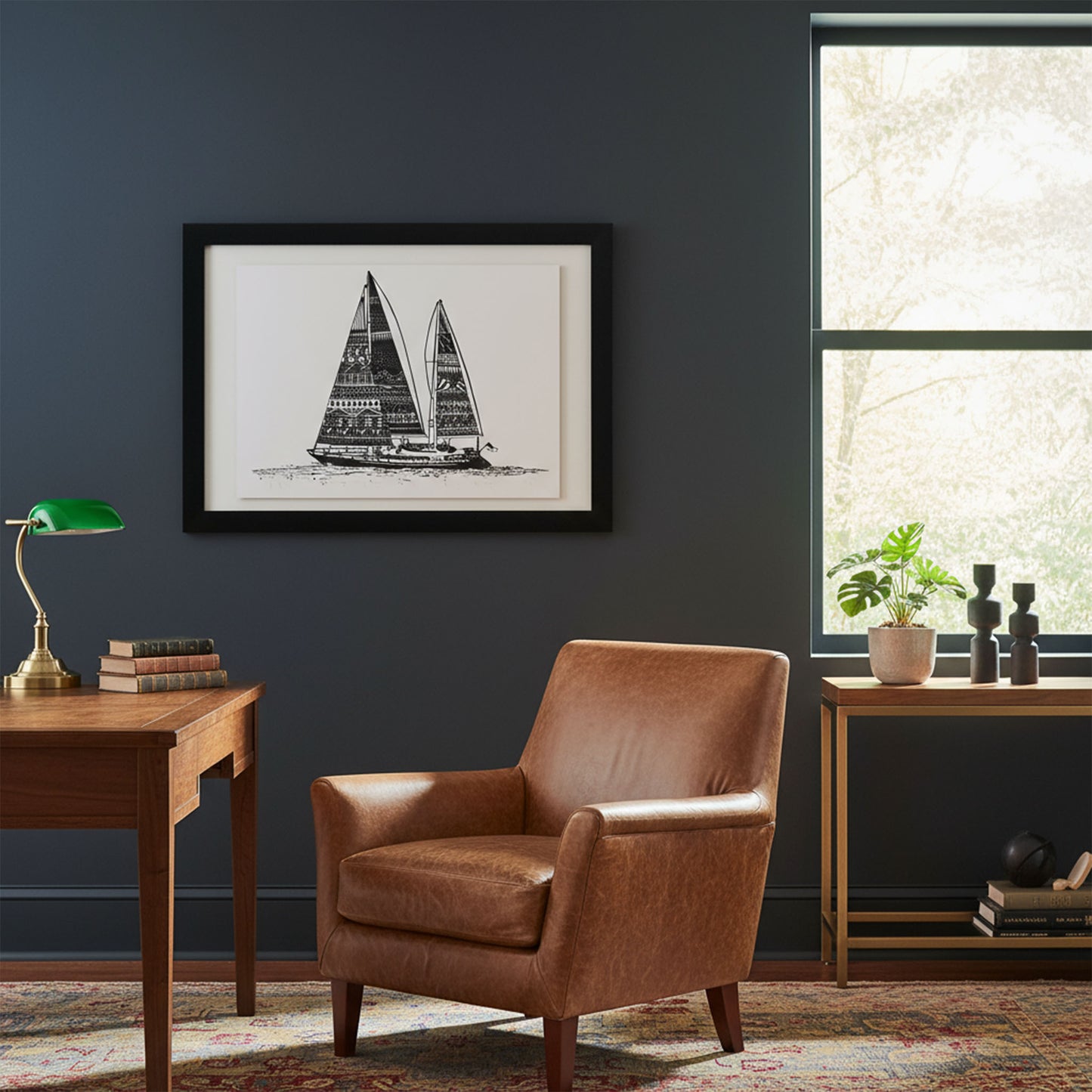 Brown leather armchair in a room with a framed sailboat print on the wall, a desk, and a window.