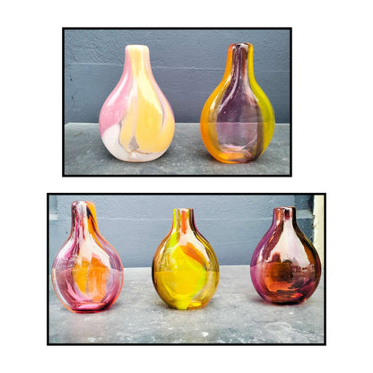 Handcrafted glass bud vases with swirled pink, orange and yellow colors in organic teardrop shapes