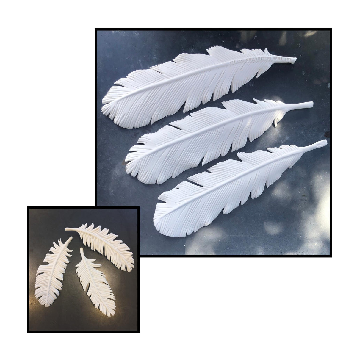 Three large white porcelain feathers by Lyn Rigg, showing their fine carved barbs and tapered forms against a dark background.
