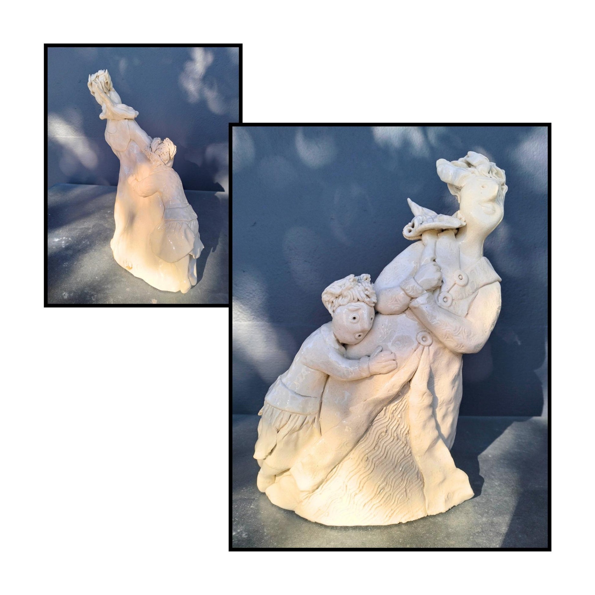 Resilience, original clay sculpture by Mandy Olson, woman leaning into wind with umbrella and child clinging to her skirts, clear glazed clay

