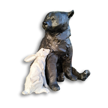 Hand-sculpted ceramic bear and rabbit titled "Secret Crush" by Kylie Matheson – a tender moment captured in clay, full view