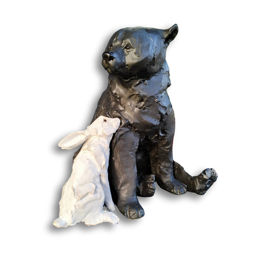 Hand-sculpted ceramic bear and rabbit titled "Secret Crush" by Kylie Matheson – a tender moment captured in clay, full view