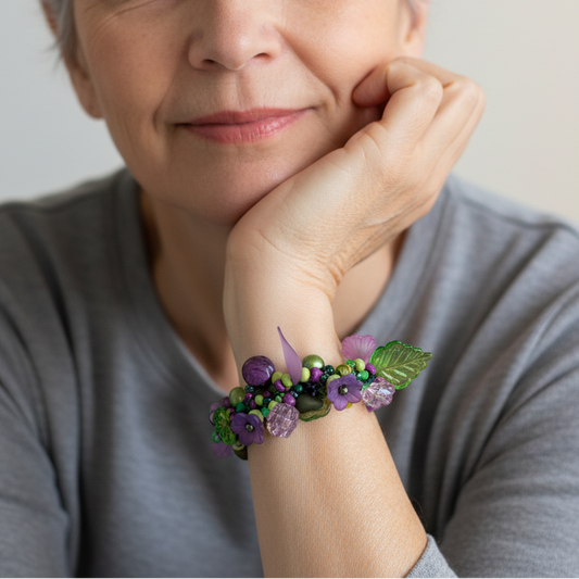 Square jewelry photography of woman wearing Judith Bradley purple and green beaded bracelet