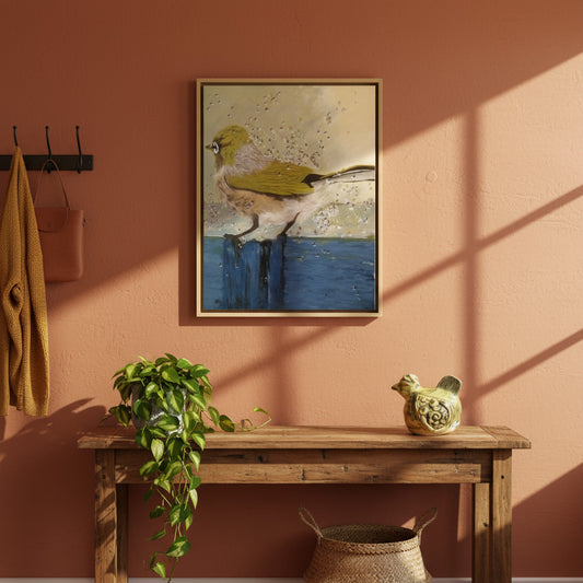 Framed artwork of a bird on a pink wall above a wooden console table with decorative items.