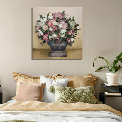 Floral painting above a bed with decorative pillows and a plant.