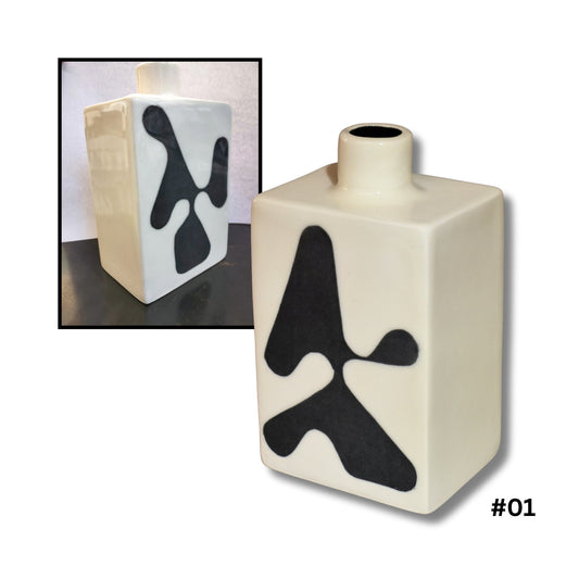 White ceramic bottle vase with bold black abstract design handcrafted by Greg Melville
