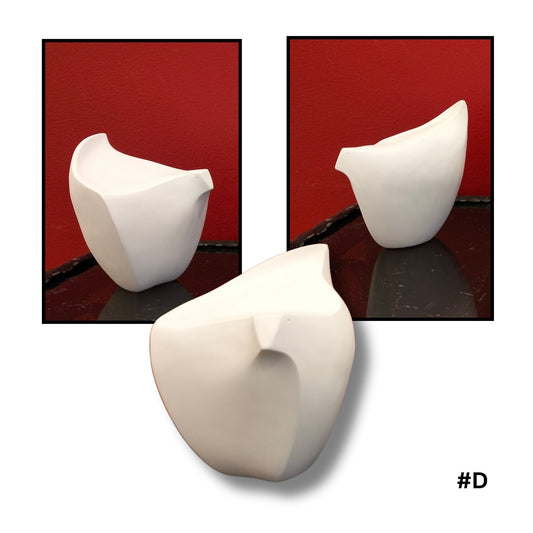 White ceramic bird  sculpture #D on a reflective surface with a red background