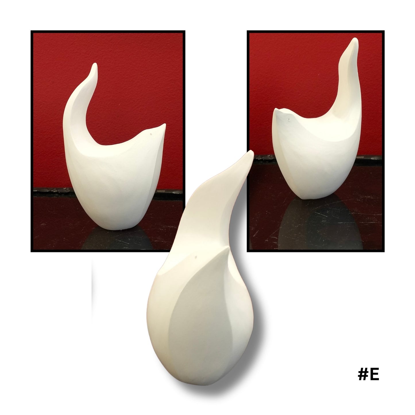 White ceramic bird  sculpture #E on a reflective surface with a red 