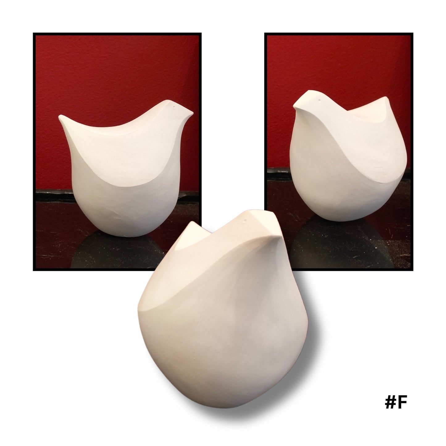 White ceramic bird  sculpture #F on a reflective surface with a red 