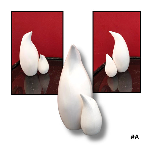 Mother and child White Earthenware Clay Penguin sculpture A, showing three views on a reflective surface with red background