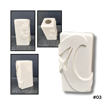 White ceramic vase with raised letter A in sculptural relief handcrafted by Greg Melville
