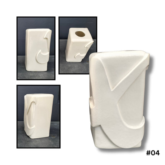 White ceramic vase with raised X design on  the front and side on a gray background